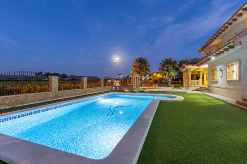 a swimming pool in the backyard of a house at Fields & Beachside Villa by Fidalsa in Jacarilla