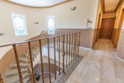 a spiral staircase in a home with a round ceiling at Fields & Beachside Villa by Fidalsa in Jacarilla