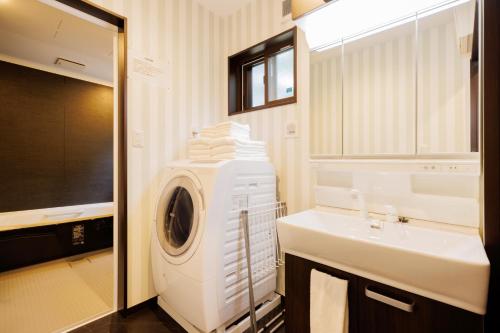 a bathroom with a washing machine and a sink at Re Start - Hot Spring Villa - Zao Sansuien Gaia Re - Vacation STAY 54075v in To-katta