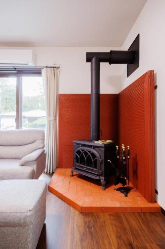 a living room with a stove in a room at Re Start - Hot Spring Villa - Zao Sansuien Gaia Re - Vacation STAY 54075v in To-katta