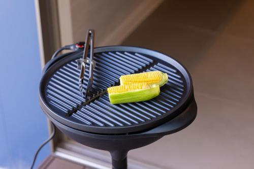 a grill with a corn and tongs on it at mion - Vacation STAY 52998v in Hota