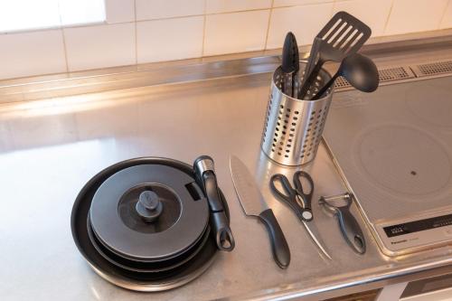 a counter top with a plate and utensils on it at mion - Vacation STAY 52998v in Hota