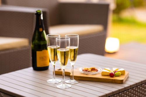 a table with three glasses of champagne and a bottle of wine at mion - Vacation STAY 52998v in Hota