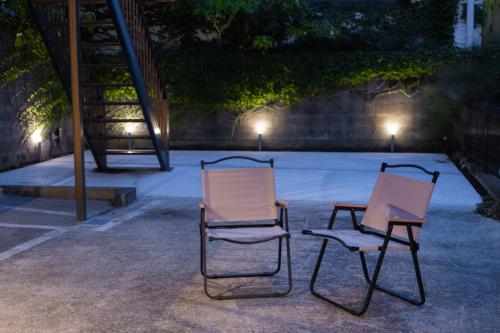 two chairs and a table on a patio at night at mion - Vacation STAY 52998v in Hota