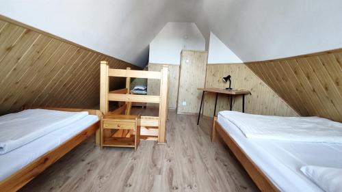 a small room with two beds and a table at Pokoje Gościnne Barka - 300m do RESTAURACJI - 900m do JEZIORA i VELO CZORSZTYN in Kluszkowce