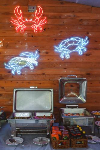 three televisions and signs on a wall at Samed Seaside Resort in Ko Samed