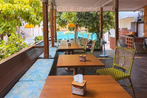 a row of tables and chairs on a patio at Samed Seaside Resort in Ko Samed