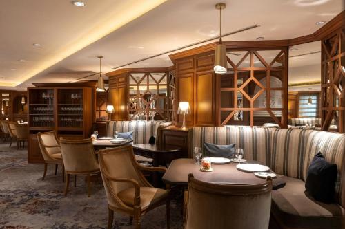 a restaurant with tables and chairs in a room at Sheraton Grand Taipei Hotel in Taipei