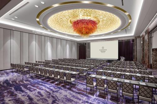 a conference room with chairs and a large chandelier at Sheraton Grand Taipei Hotel in Taipei