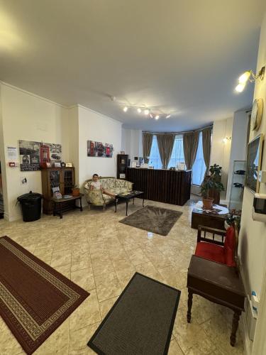 a living room with a couch and a table at Carlton Court Hotel Eastbourne in Eastbourne