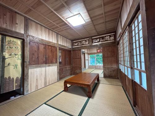 a room with a table in the middle of it at Akagawara no Kominka Pukarasa - Vacation STAY 42241v in Imadomari