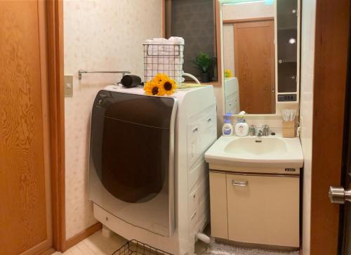 a television in a bathroom with a sink at Yatsugatake Villa FOREST&DOG - Vacation STAY 53545v in Hokuto