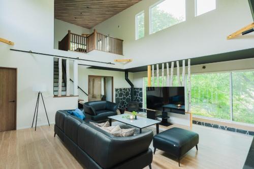 a living room with a couch and a tv at SORA - Zao Sansuien Gaia Resort - Vacation STAY 54039v in To-katta