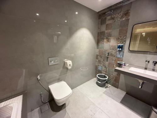 a bathroom with a toilet and a sink at Chandi Haveli in Khed