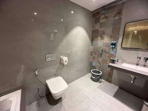 a bathroom with a toilet and a sink at Chandi Haveli in Khed