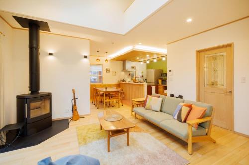 a living room with a couch and a stove at ZAO Hotaru no niwa - Vacation STAY 54095v in To-katta
