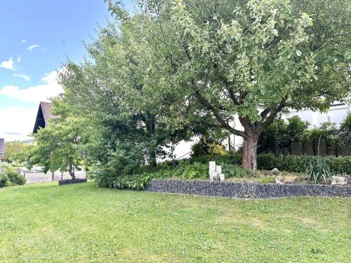 a grave in a yard next to a tree at Ferienwohnung Rundblick Rhön in Ehrenberg