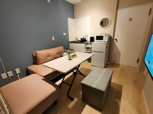 a small living room with a table and a kitchen at MaMe Inn, - Vacation STAY 80189v in Saitama