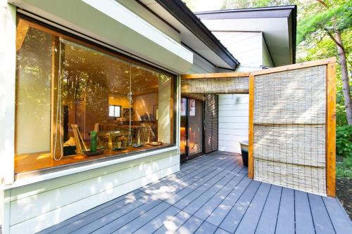 a house with a large window on a deck at Hot Spring Villa - Inroan - Vacation STAY 54229v in To-katta