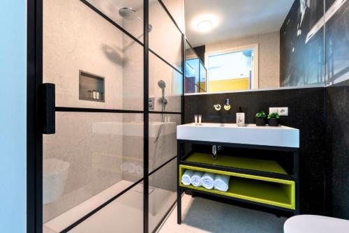 a bathroom with a sink and a shower at Designer Suite in Hotspot Location w Fast Wi-Fi in Tilburg
