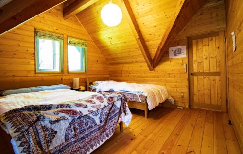 a bedroom with two beds in a wooden cabin at Shibatagun - House - Vacation STAY 17461 in Aone