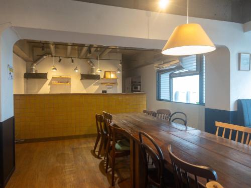 a dining room with a long wooden table and chairs at HARMONY HOTEL Urawa - Vacation STAY 18310 in Saitama