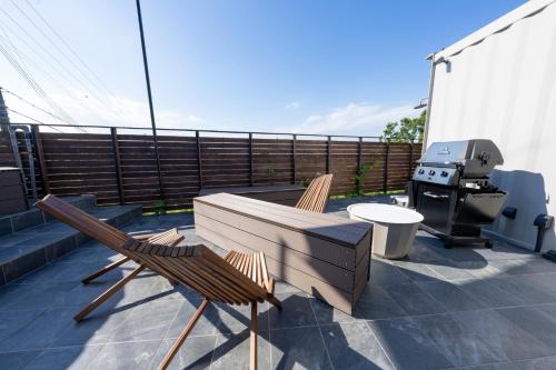 a patio with two chairs and a table and a grill at AKESUKE - Vacation STAY 67241v in Minamiawaji