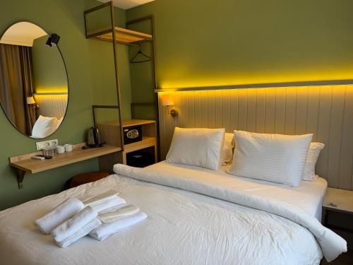 a hotel room with a bed with towels on it at OTTO X Hotel in Kavaklıdere