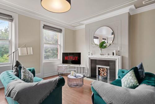 a living room with two couches and a fireplace at Georgian Apartment In Yorkshire - Parking in Wakefield