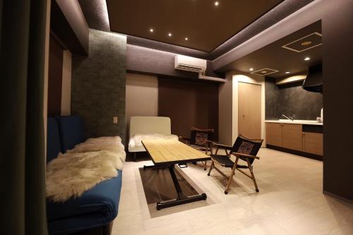 a living room with a couch and a table at Lions Mansion Sapporo Jozankeisanbankan 206 - Vacation STAY 17731 in Sapporo