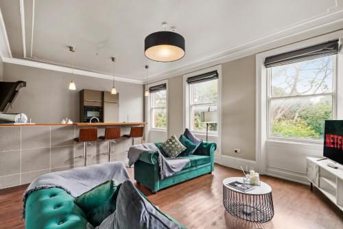 a living room with a couch and a table at Georgian Apartment In Yorkshire - Parking in Wakefield