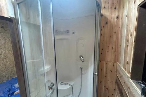 a shower with a glass door in a bathroom at Osoto Sauna & Glamping - Vacation STAY 91575v in Hokota