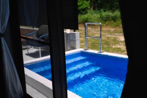 a view of a swimming pool through a window at RYUKYU BREEZE No,1, No,2, No,3, No,4 - Vacation STAY 91466v in Nago