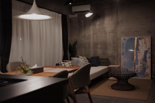 a living room with a couch and a table at RYUKYU BREEZE No,1, No,2, No,3, No,4 - Vacation STAY 91466v in Nago