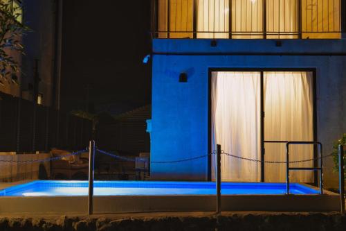 a swimming pool with blue lighting in front of a building at RYUKYU BREEZE No,1, No,2, No,3, No,4 - Vacation STAY 91504v in Nago