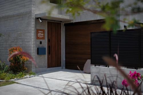 a front door of a house with a wooden door at RYUKYU BREEZE No,1, No,2, No,3, No,4 - Vacation STAY 91504v in Nago