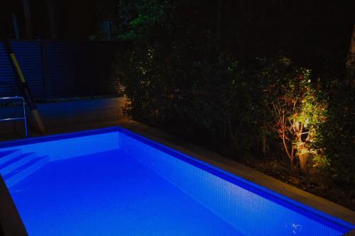 a blue swimming pool in a backyard at night at RYUKYU BREEZE No,1, No,2, No,3, No,4 - Vacation STAY 91504v in Nago