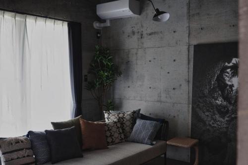 a living room with a couch and a window at RYUKYU BREEZE No,1, No,2, No,3, No,4 - Vacation STAY 91504v in Nago