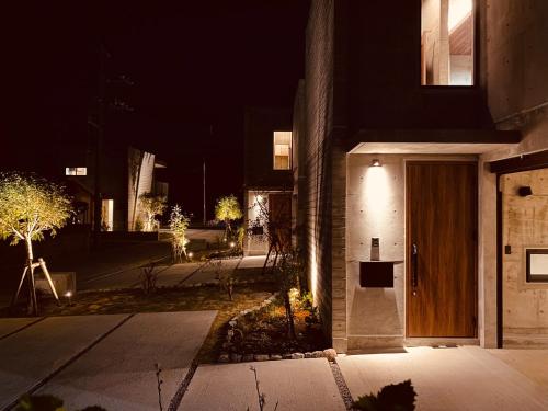 a building with a wooden door at night at RYUKYU BREEZE No,1, No,2, No,3, No,4 - Vacation STAY 91504v in Nago