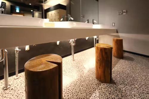a bathroom with a large sink and two wooden stools at Lions Mansion Sapporo Jozankeisanbankan 206 - Vacation STAY 17731 in Sapporo