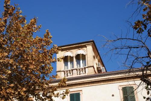 a building with a clock tower on top of it at Villa Helvetia in Grottammare