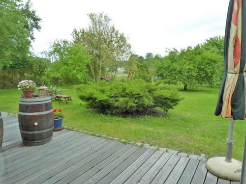 a wooden deck with a garden with plants and trees at Ferienhaus "Landhaus Speck" Objekt-ID 12131-6 in Speck
