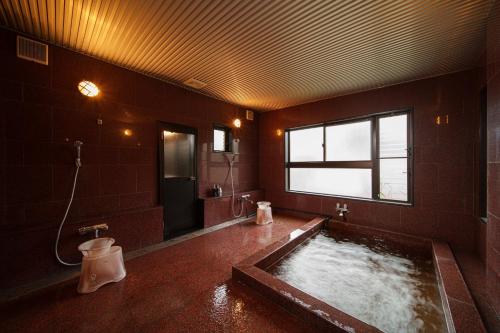 a large bathroom with a bath tub with a window at Suida no Yado - Vacation STAY 04892v in Yufuin
