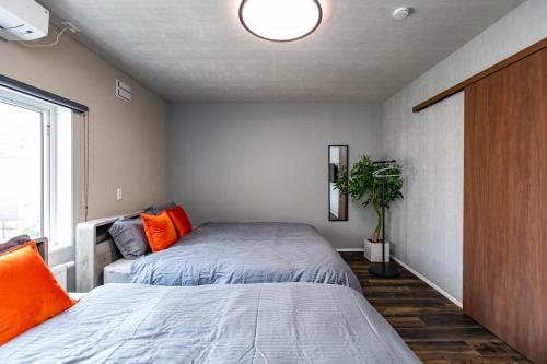 a bedroom with two beds and a window at S9W13 LABOINN - Vacation STAY 06250v in Sapporo