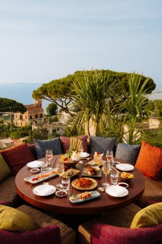 a table with food and wine glasses on it at Jumeirah Capri Palace in Anacapri