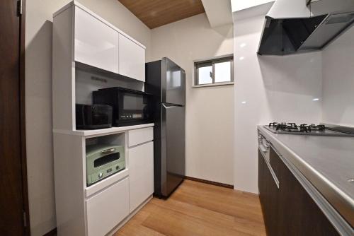 a kitchen with a refrigerator and a stove top oven at BLUESOLARE Aqua - Vacation STAY 14988v in Hirara