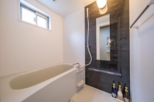 a bathroom with a tub and a shower at BLUESOLARE Aqua - Vacation STAY 14988v in Hirara