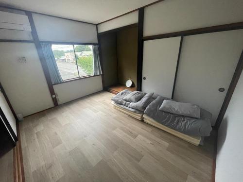 a bedroom with a bed and a large window at Tatu Stay&Bar - Vacation STAY 17780 in Shimanokoshi