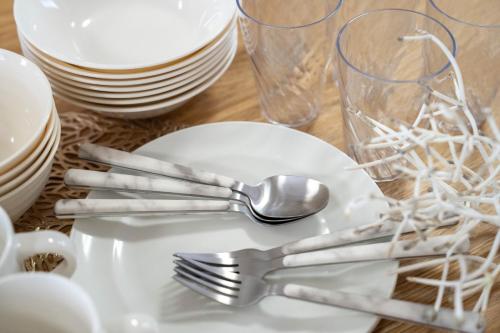 a table with forks and spoons on a plate at Flex cella satozuka - Vacation STAY 17763 in Sapporo