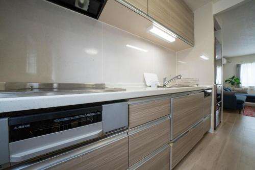 a kitchen with a sink and a stove at Flex cella satozuka - Vacation STAY 17763 in Sapporo